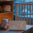 Load image into Gallery viewer, Dreamer baby sound machine in a softly lit nursury (Peach-Dreamer)